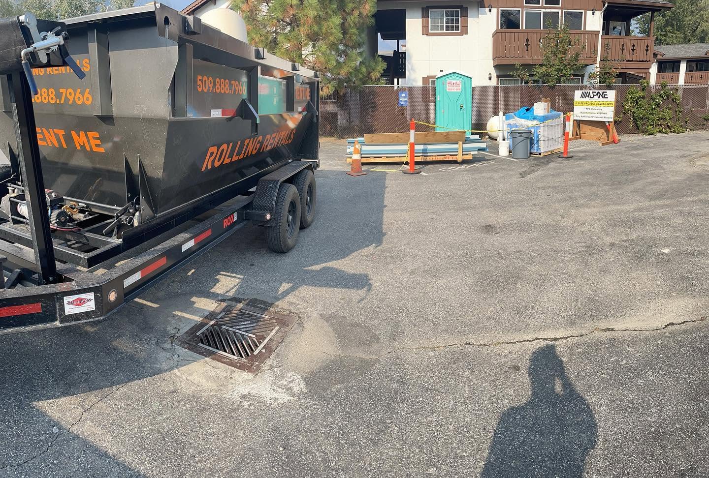 Rolling Rentals dropping off a contractor dumpster at a jobsite in Chelan County WA
